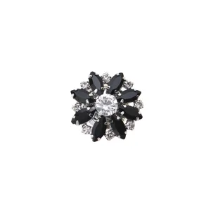 Close-up detail of the exquisite rhinestone flower button with sparkling black crystal stones.