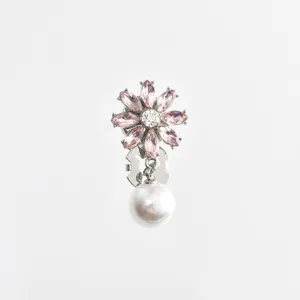 Close-up view of the exquisite pink crystal flower collar clip featuring a glowing pearl pendant.