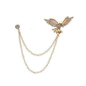 Retro gold eagle wing brooch with double chain and rhinestone detail, perfect suit accessory.
