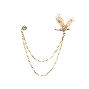 Detailed closeup of retro gold eagle brooch with sparkling rhinestones and double chains.