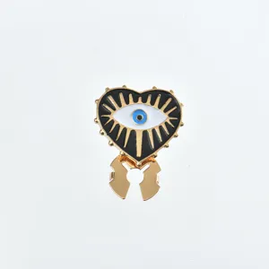Close-up detail view of the evil eye heart shirt collar pin, stylish metallic fashion accessory.