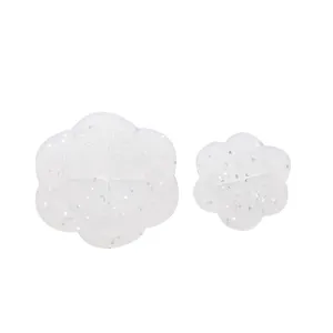 Close-up detail view of translucent flower-shaped silicone items with glitter finish.