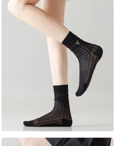 Detail view of black sheer mesh mid-calf socks with cute bow, breathable summer hosiery.