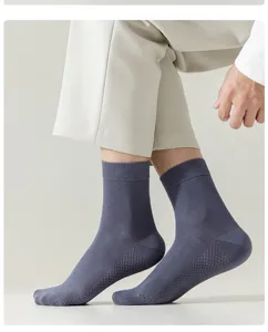 Close-up detail of men's breathable mid-calf cotton socks in gray blue, ribbed cuff and mesh.