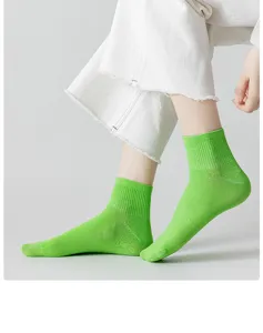 Close-up detail shot of bright green ribbed socks showing breathable soft cotton texture.