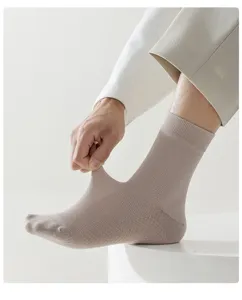 Men's breathable mid-calf cotton socks detail, showing elastic stretch and mesh fabric.