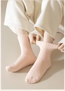 Cozy pink ribbed knit women winter socks detail shot, soft thermal fuzzy sock fabric.