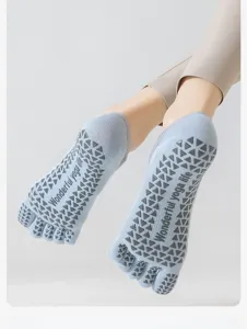 Close-up detail showing the five-toe design and anti-slip silicone grip dots on the sole.
