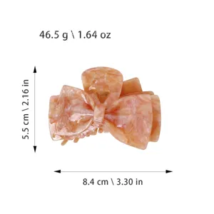 Elegant bow hair claw clip, pinkish orange acetate material, stylish shark hair accessory.