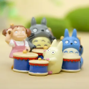 Close-up of cute anime character miniature drum figurines, creative desktop decoration.