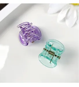 Mini candy color hair claw detail view, transparent plastic shark clip for cute daily hairstyles.