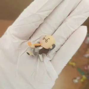 Detail view of a cute cartoon old man 3.5mm headphone jack dust plug for phone and laptop.