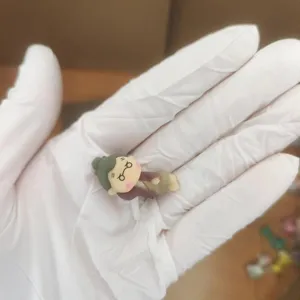 Close-up detail of the cute miniature character dust plug figurine, showing fine craftsmanship.