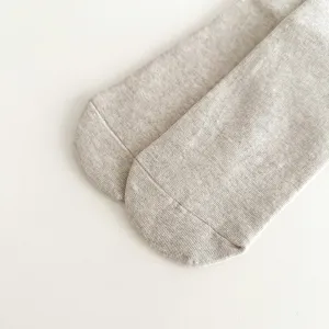 Detailed view of women's solid color fine ribbed mid-tube cotton socks in light grey.