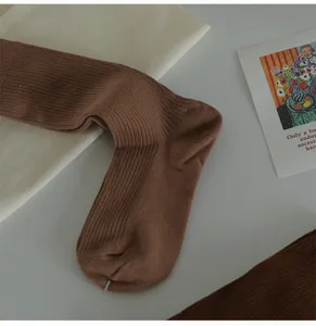 Close-up of brown ribbed cotton crew socks showing soft knit texture and fine craftsmanship.