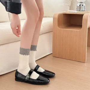 Detailed shot of comfortable cotton mid-calf socks with cute ruffled grey ribbed cuffs.