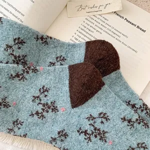 Retro blue patterned winter mid-calf socks with contrast brown heel and cozy knit texture.