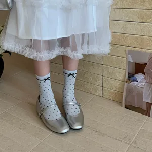 Grey-blue sheer polka dot mesh socks paired with silver Mary Jane shoes, sweet style.