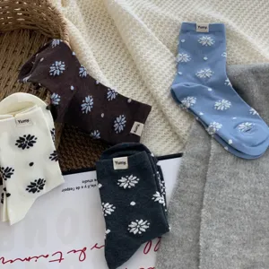 Cozy winter cotton mid-tube socks with snowflake pattern and woven label detail