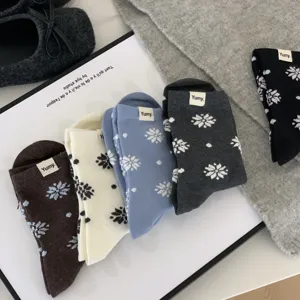 Cozy winter women's mid-tube cotton socks with snowflake and polka dot patterns, soft and warm.