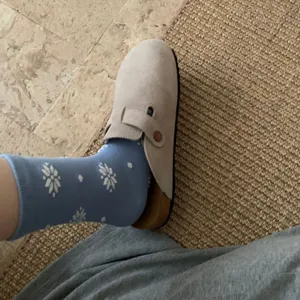 Detailed view of winter warm cotton mid-tube socks with cute snowflake and dot pattern.