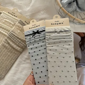 Detailed view of grey-blue polka dot mesh ruffle bow stack socks, ins style soft girl look.