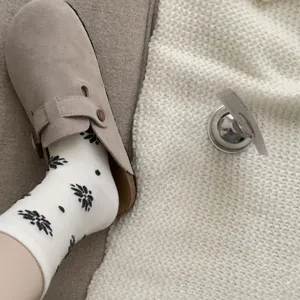 Comfortable cozy winter suede clogs and stylish patterned cotton socks for women daily.