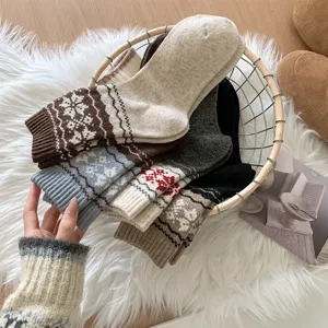 Gros plan de chaussettes en laine d'hiver rétro avec motifs de flocons de neige douillets.