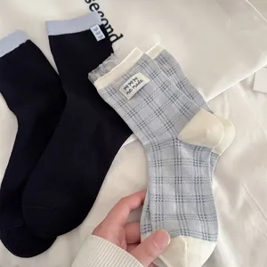Detailed shot of women's cute plaid mesh socks with delicate lace trim, soft cotton fabric.