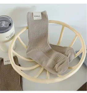 Comfortable ribbed mid-tube socks in khaki color, featuring a neat tag and soft knit texture.