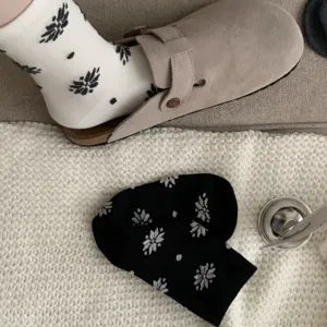 Detail shot of cozy winter cotton socks featuring charming floral and dot patterns.
