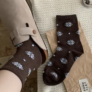 Winter women's mid-tube cotton socks with retro snowflake and polka dot patterns, cozy and warm.