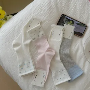 Detailed view of sweet floral lace trim cute summer stacking socks, breathable cotton material.
