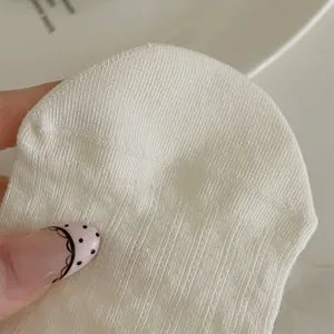 Detailed close-up view of white vertical striped knit socks, showing soft fabric and texture.