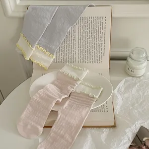 Sweet ruffles mid-tube socks detail view, showing delicate vertical stripes and contrast wavy edge.