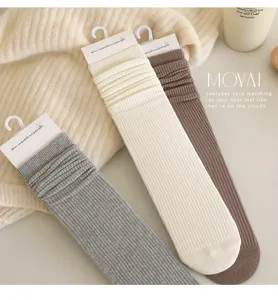 Ribbed knit knee high socks detail, soft long cotton stockings in neutral colors for daily wear.