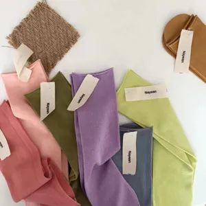 Candy color ribbed cotton knit socks detail showing soft pastel hues and rolled cuffs.