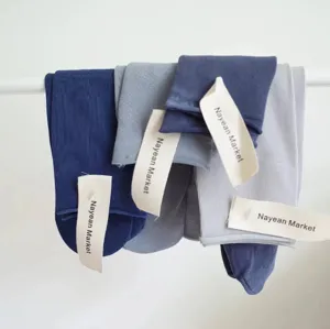 Detail view of comfortable combed cotton mid-tube socks in candy colors hanging on display.