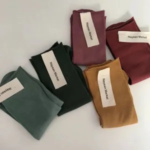 Detailed view of colorful combed cotton rolled-cuff mid-tube socks flat display.