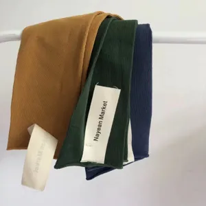 Detailed view of women's ribbed cotton crew socks in vibrant colors, brand tags.