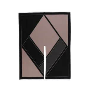 Detailed view of women geometric color block knit cape shawl showing fine texture and slit hem.