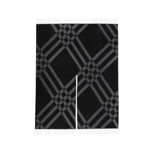 Close-up of black and grey plaid fringe cape detail showing classic pattern and texture.
