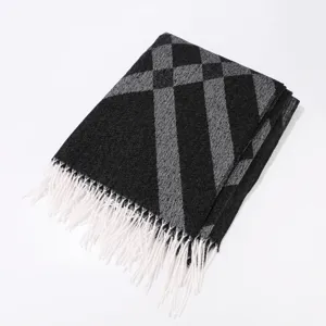Detailed view of winter plaid tassel scarf, classic black and grey pattern for women.
