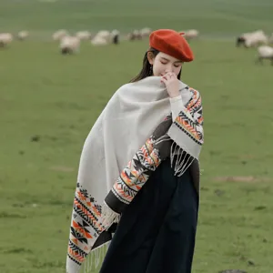 Ethnic style tassel cape detail showing geometric patterns and soft imitation cashmere texture.