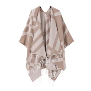 Close-up detail of the cozy winter women's tassel plaid cashmere-feel cape shawl.