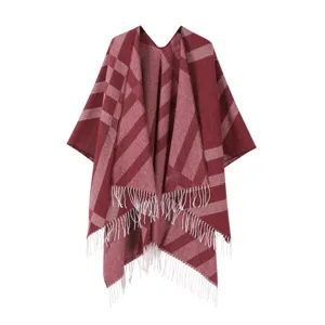 Detail view of the winter tassel poncho, featuring a classic plaid pattern and soft fabric.