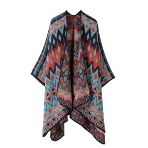 Ethnic style geometric knitted cape detail view, vibrant colorful patterns and cozy texture.