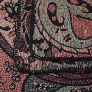Close-up view of the vintage paisley pattern texture and dark stitched hem on the soft fabric.
