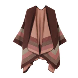 Detailed view of warm knitted striped poncho shawl, soft winter cape texture design.