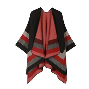 Detailed view of women knitted striped shawl, cozy autumn winter warm cape poncho cardigan.